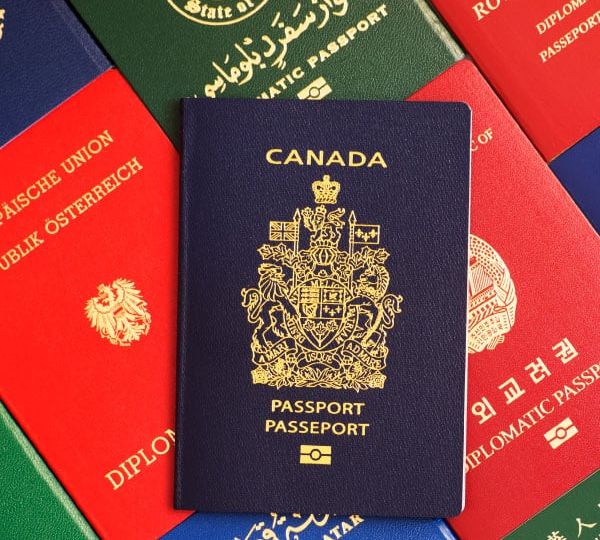 A Canadian passport superimposed on passports from various countries, illustrating Skrivanek's document translation and notarisation services.